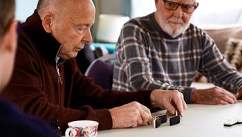 two men playing dominoes