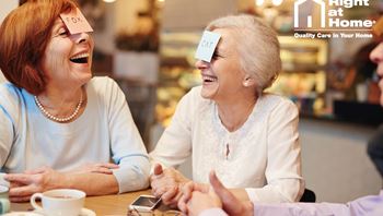 Ladies laughing with post it notes on their heads