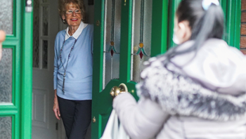 Client receiving shopping from CareGiver