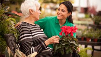 Caregiver with client in garden centre
