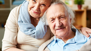 Elderly couple at home; smiling