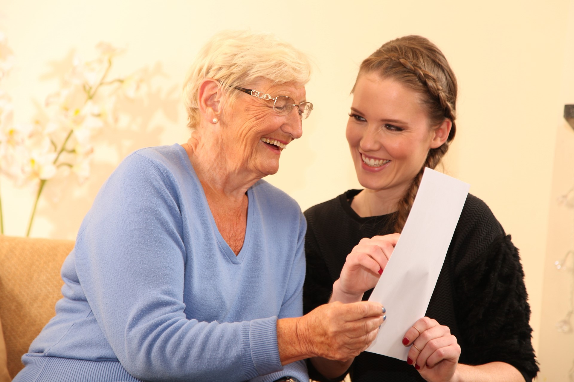 Female Client And Caregiver Reading A Document