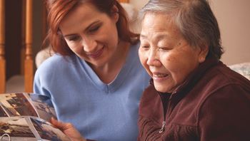 Caregiver looking through at photographs with a client
