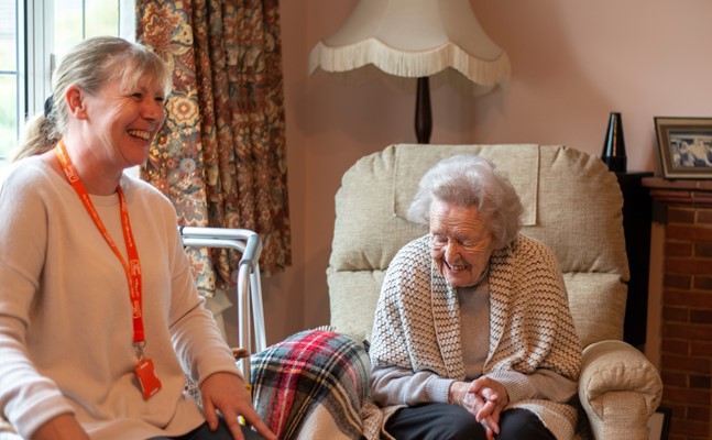 Elderly Client and Carer laughing together