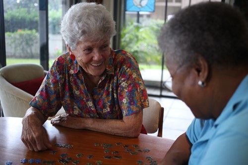 Carer and client doing a puzzle