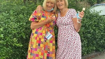 Two CareGivers from Right at Home Solent posing with Sweet Treats