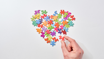 Colourful puzzle pieces in the shape of a heart