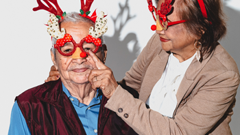 Elderly couple with Christmas glasses
